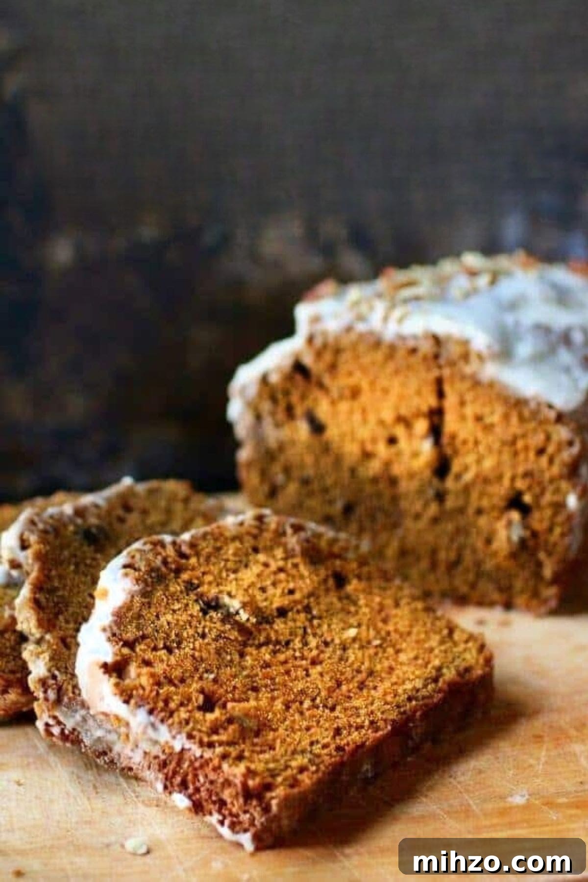 Classic Pumpkin Spice Quick Bread Recipe for Fall Baking 2 Close up of a loaf of old-fashioned pumpkin spice bread that's been sliced.