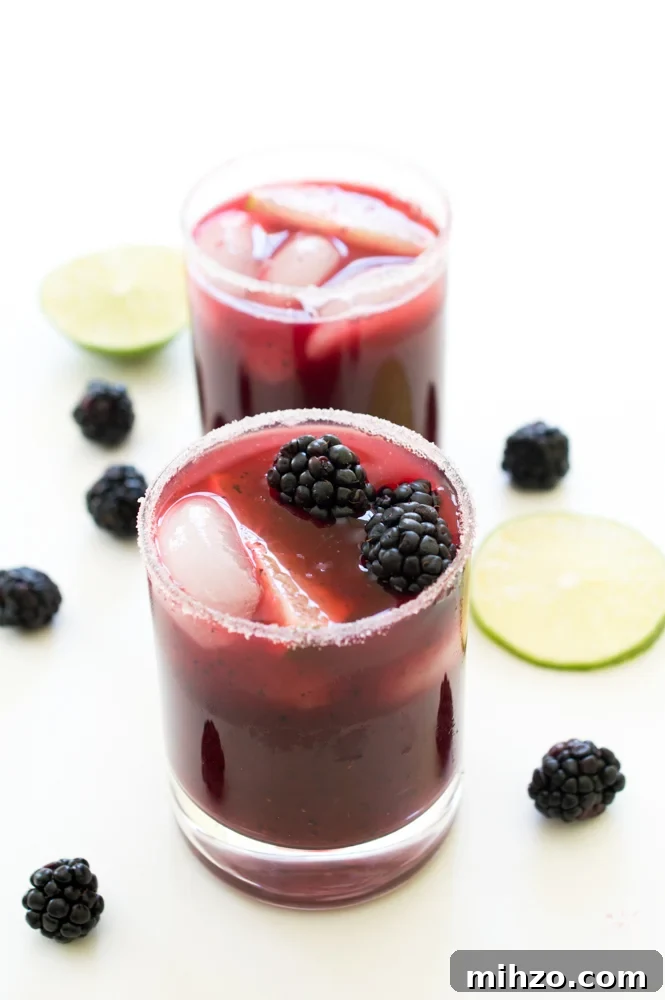 Refreshing Mixed Berry Margaritas Recipe for Summer Cocktails 2 Two Mixed Berry Margaritas in glasses with blackberries and lime wedges as garnish