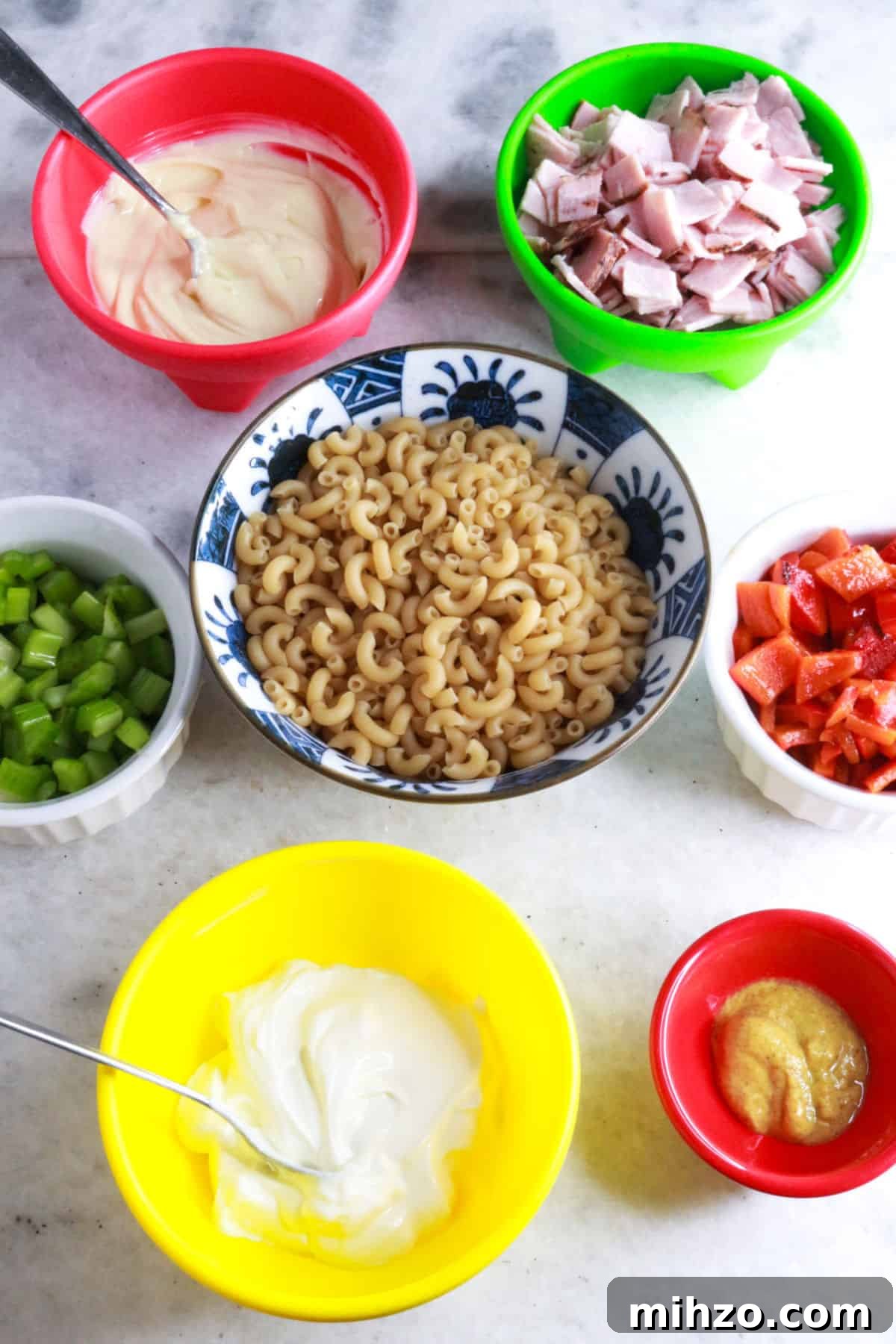 Mexican Macaroni Pasta Salad with Creamy Dressing 3 Bowls with sour cream, diced ham, chopped celery, macaroni noodles, roasted bell pepper, mayo, and mustard.