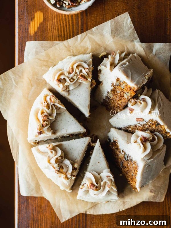 Single-Layer Funfetti Cake Recipe for Bright, Moist Celebration Cakes 16 Overhead image of single layer carrot cake frosted on parchment paper and placed on a wood dining room table.