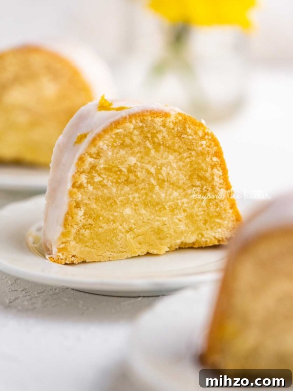 Single-Layer Funfetti Cake Recipe for Bright, Moist Celebration Cakes 17 Small lemon cream cheese pound cake slice on a small dessert plate on white background.