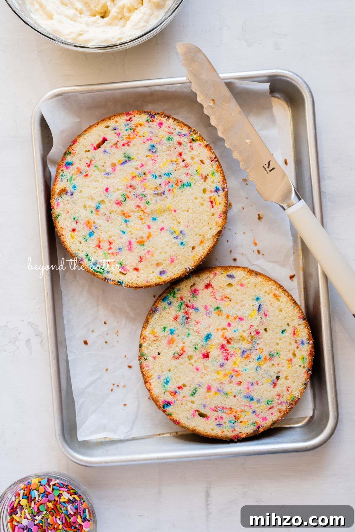 Single-Layer Funfetti Cake Recipe for Bright, Moist Celebration Cakes 6 6 inch single layer funfetti cake sliced into two layers with a serrated knife from BeyondtheButter.com | All images © Beyond the Butter®