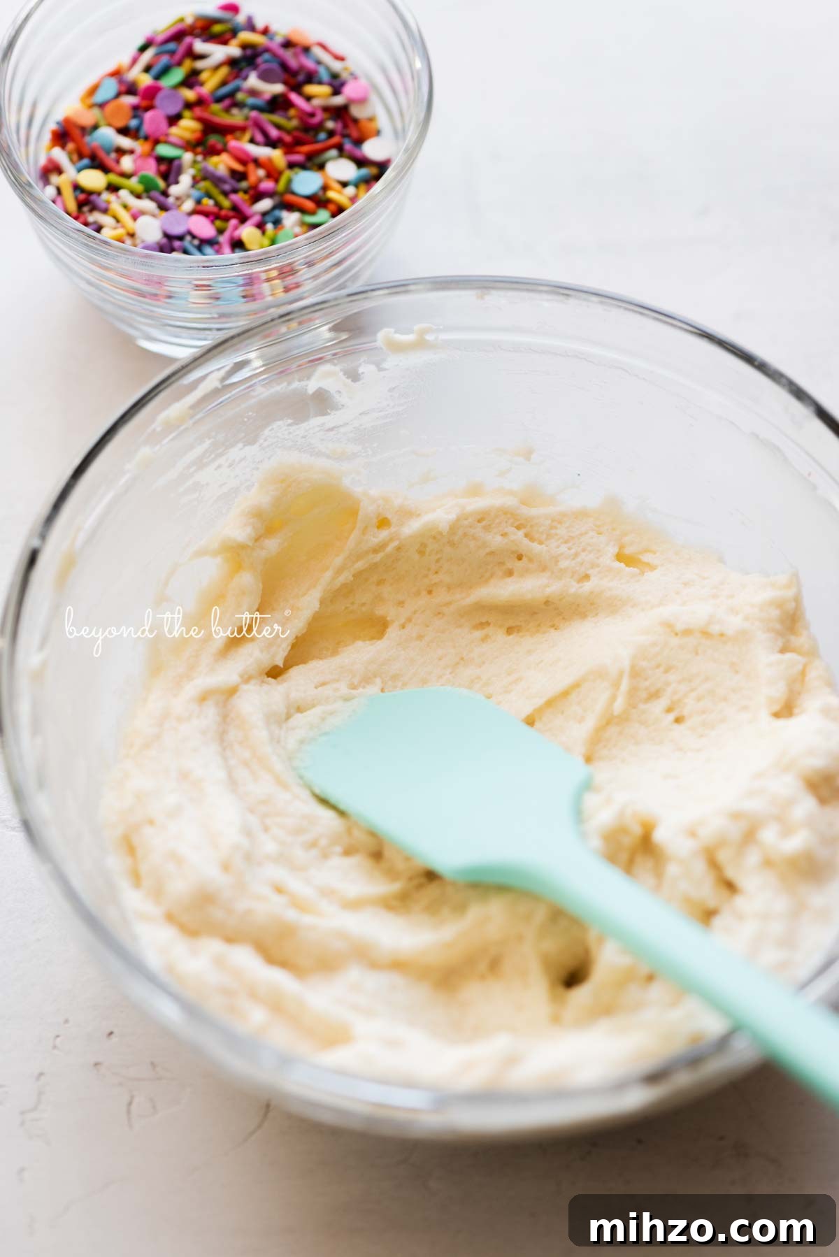Single-Layer Funfetti Cake Recipe for Bright, Moist Celebration Cakes 8 Small batch vanilla fluor buttercream frosting ready for the rainbow jimmies from BeyondtheButter.com | All images © Beyond the Butter®
