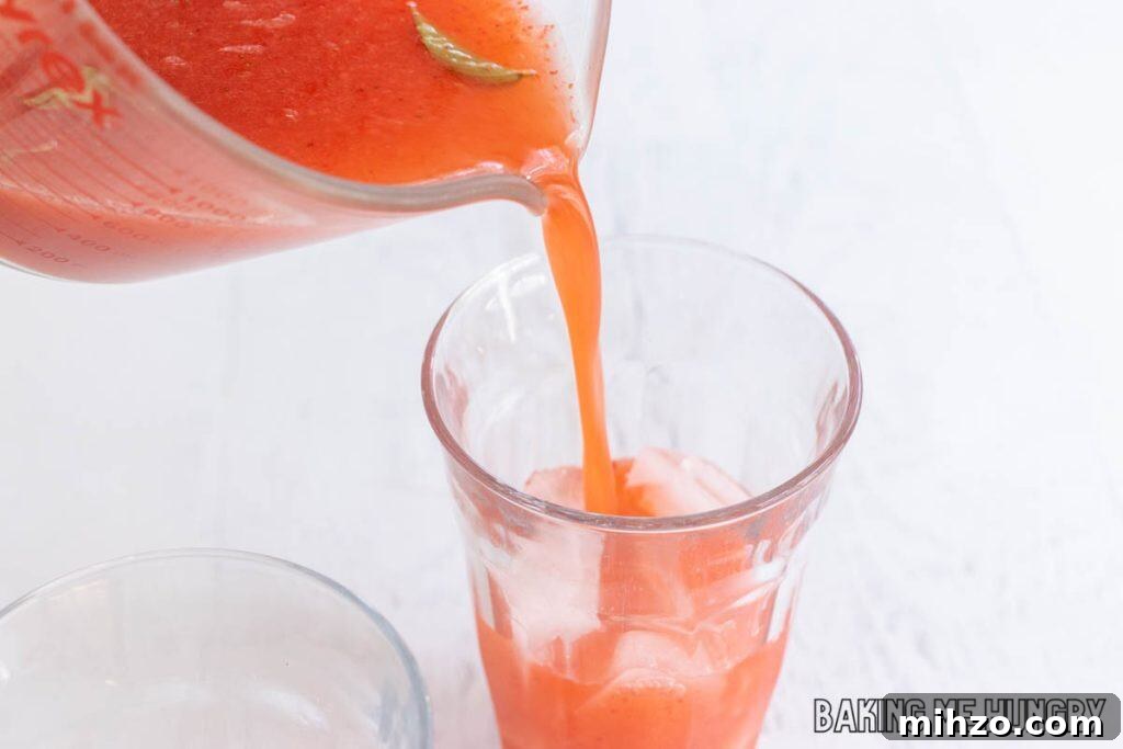 Strawberry Basil Lemonade Recipe: Refreshing Summer Drink 8 drink being poured into glass