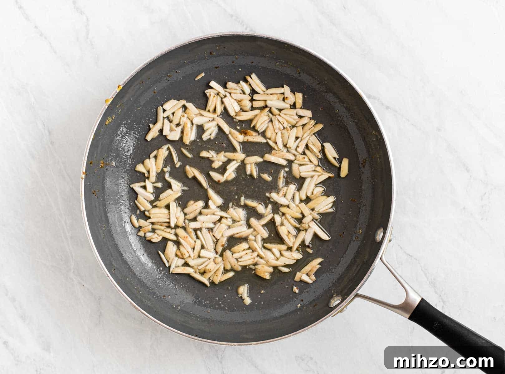 Slivered almonds in a skillet with butter.
