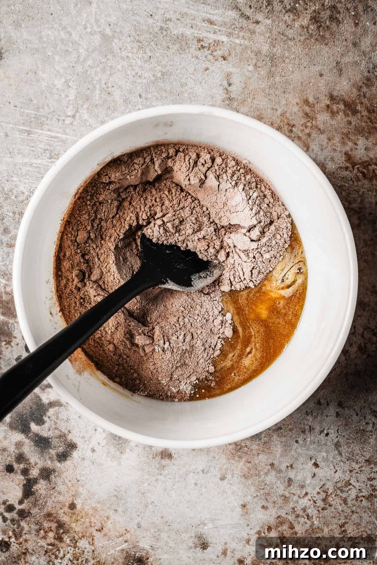 A mixing bowl with wet and dry ingredients.