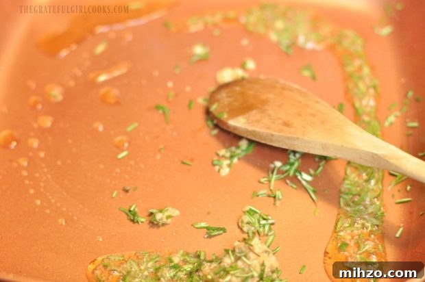 Minced garlic and rosemary cooking in skillet.