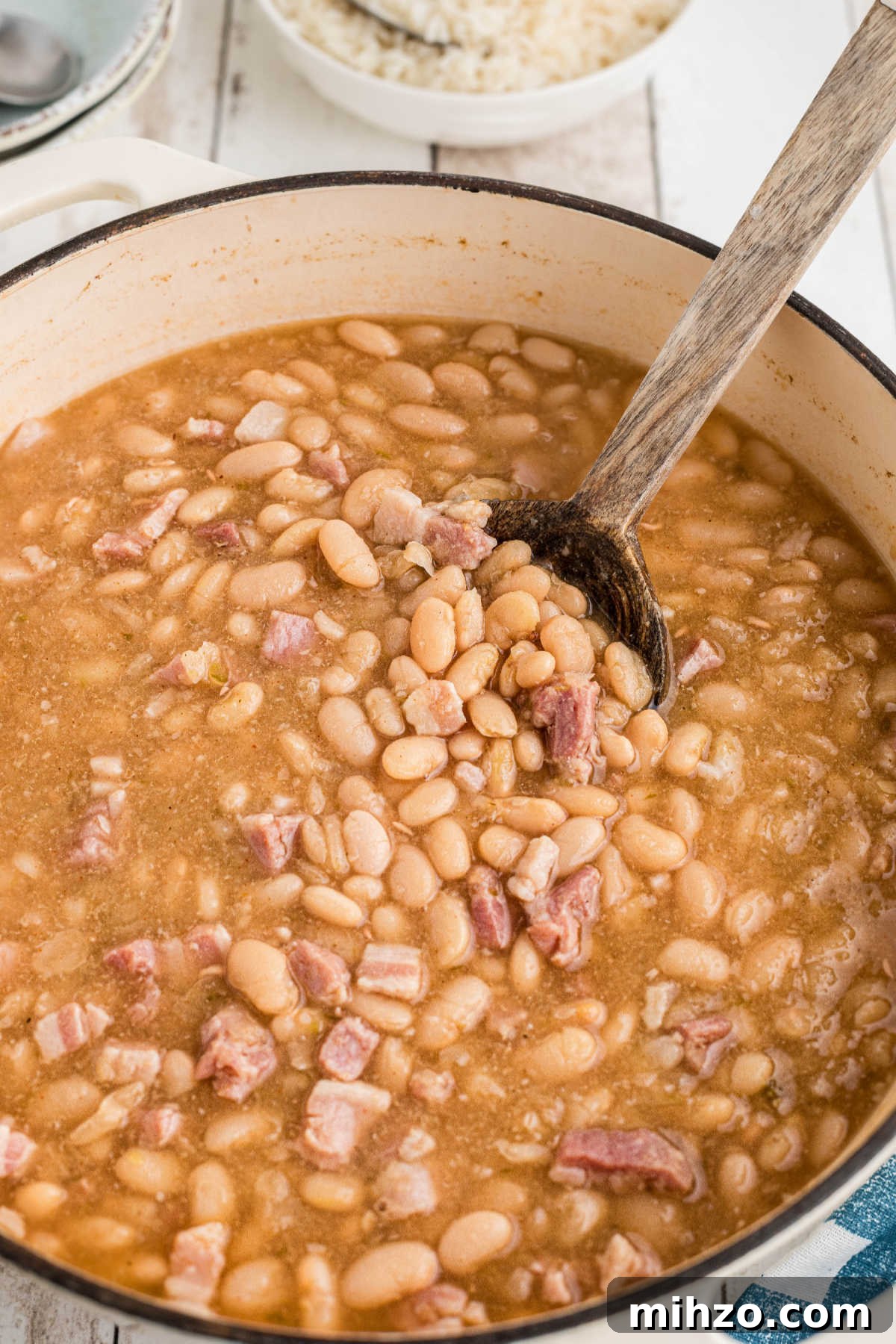 Southern-Style Great Northern Beans Recipe: Savory Slow-Cooker Method 7 A large pot of Southern Great Northern Beans with a spoon digging in.