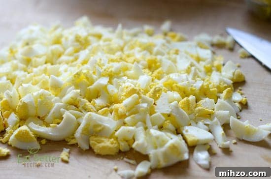 Healthy Egg Salad Recipe with Greek Yogurt @EatBetterRecipe keto egg salad with chopped eggs on board