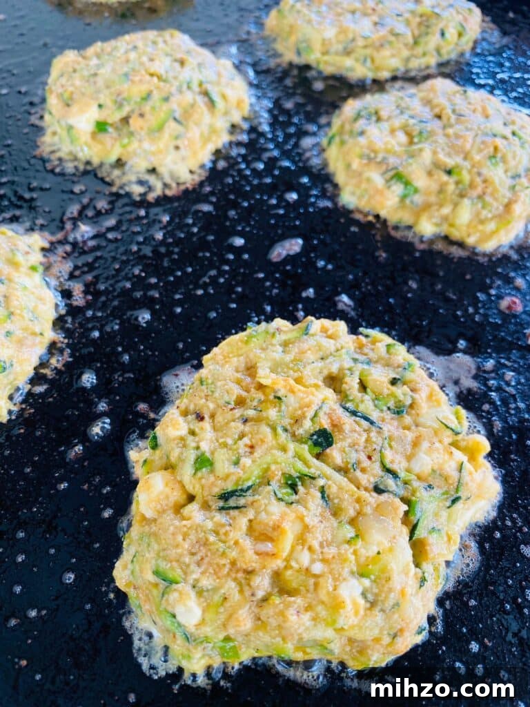 Blackstone Zucchini Feta Fritters before flipping on the griddle