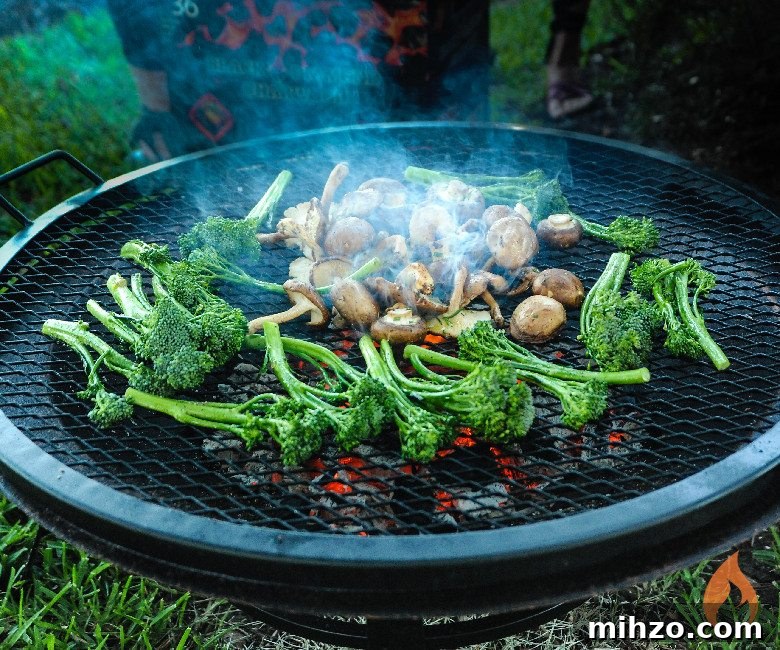 Fire Pit Grilling: Tips for Perfect Open-Fire BBQ 2 mushrooms and broccolini grilling on fire pit.