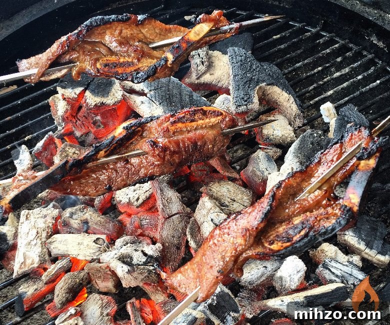 Fire Pit Grilling: Tips for Perfect Open-Fire BBQ 5 Korean Short Ribs on skewers over coals.
