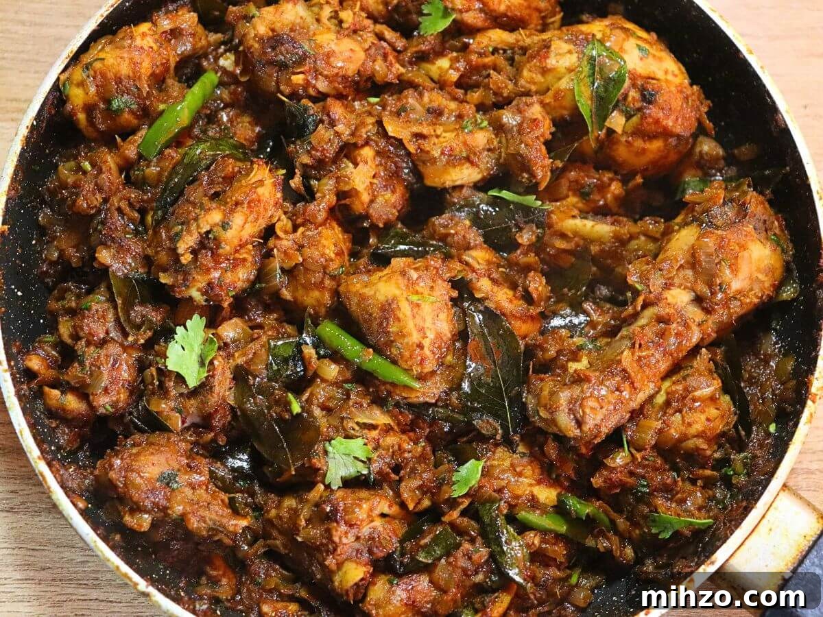Andhra-Style Crispy Chicken Fry (Kodi Vepudu) 11 Andhra Kodi Vepudu in a pan, garnished with curry leaves.