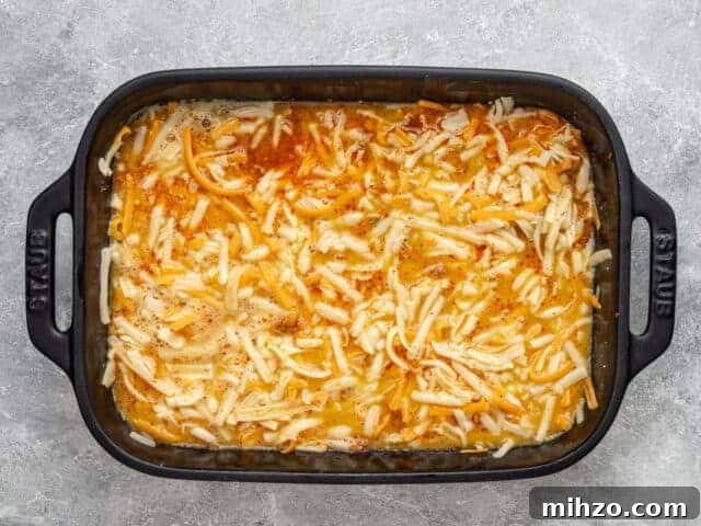 Spicy Chorizo Quiche Squares Recipe for Brunch or Parties 7 Eggs added to the sausage and cheese, and ready to bake.