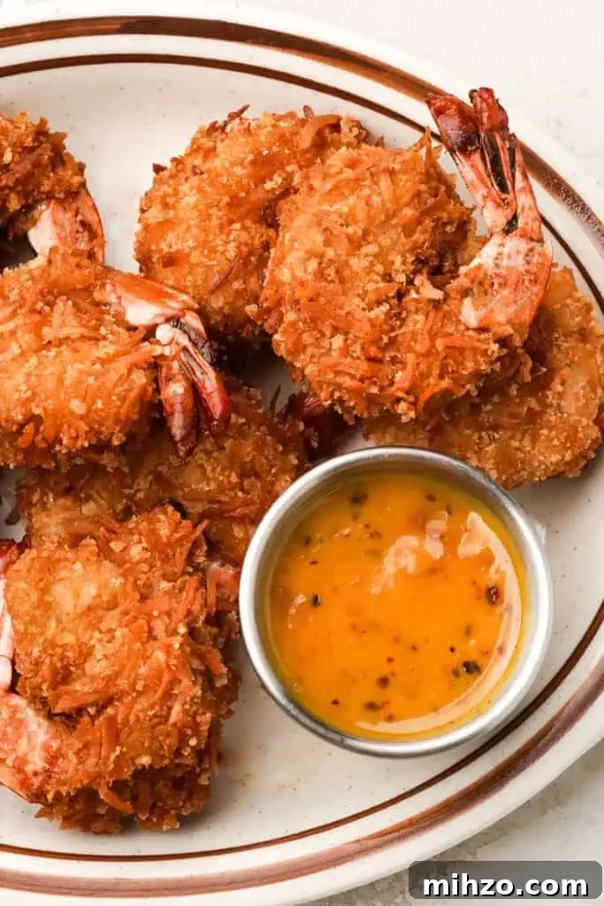 recipe for coconut shrimp five-spice coconut shrimp on a platter with honey dijon apricot sauce