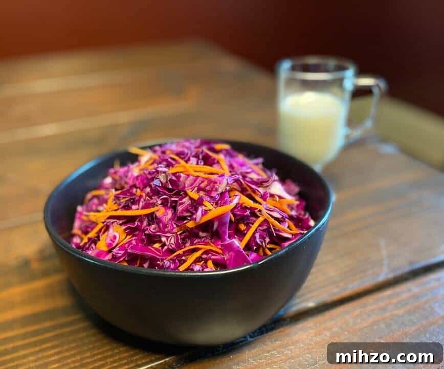 Classic Creamy Homemade Coleslaw Recipe You’ll Love 6 Shredded cabbages and carrots in a bowl.