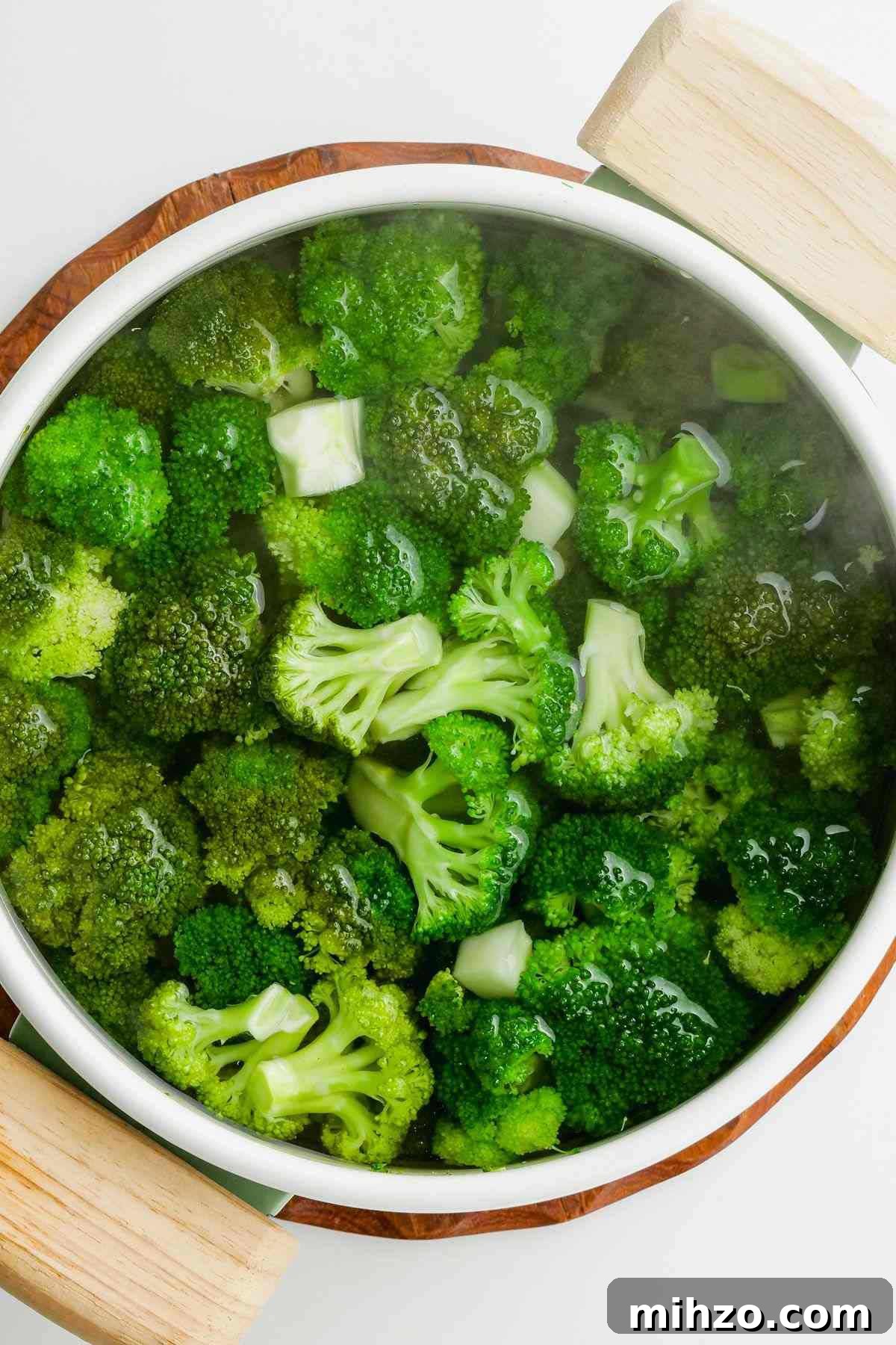 Blanch Broccoli Quickly: Perfectly Crisp, Bright Green Every Time 6 broccoli florets in white pot being blanched