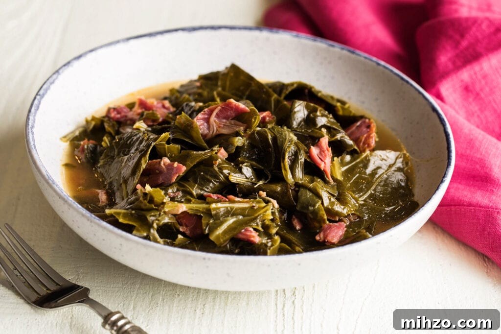 Savory Collard Greens with Smoked Ham Hocks Recipe 2 bowl of soul food collard greens with a fork and pink dinner napkin