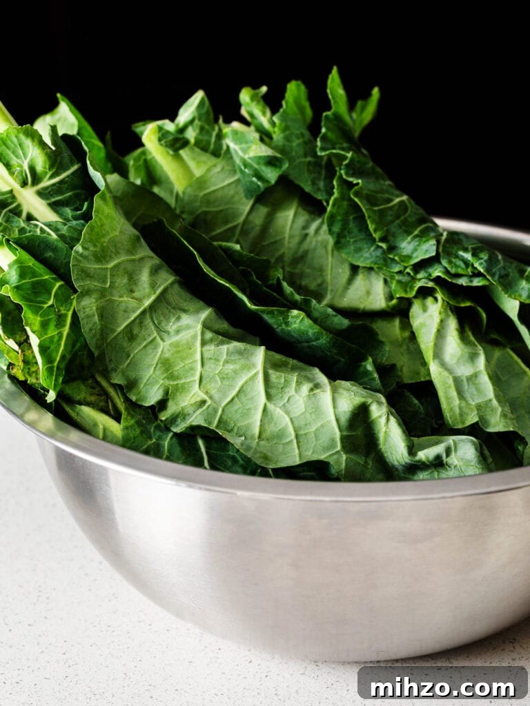 Savory Collard Greens with Smoked Ham Hocks Recipe 3 two bunches of collard greens in a large silver mixing bowl