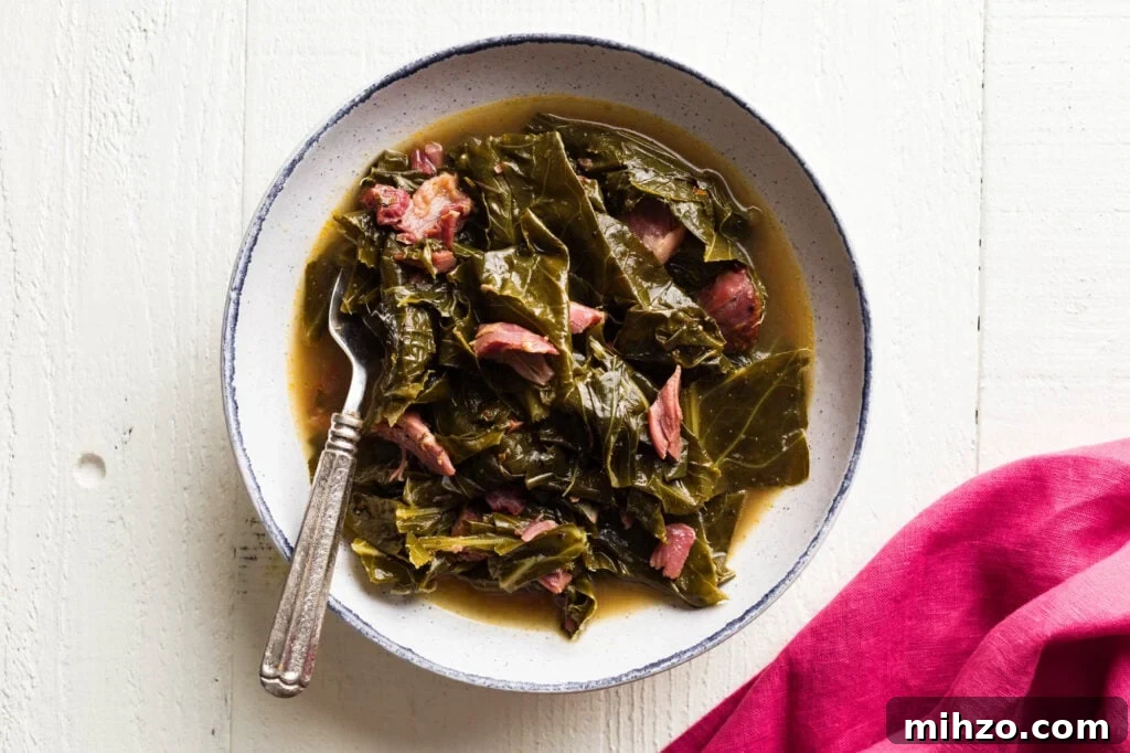 Savory Collard Greens with Smoked Ham Hocks Recipe 5 bowl of collard greens and ham hocks with a fork in it and a pink napkin laying next to it.