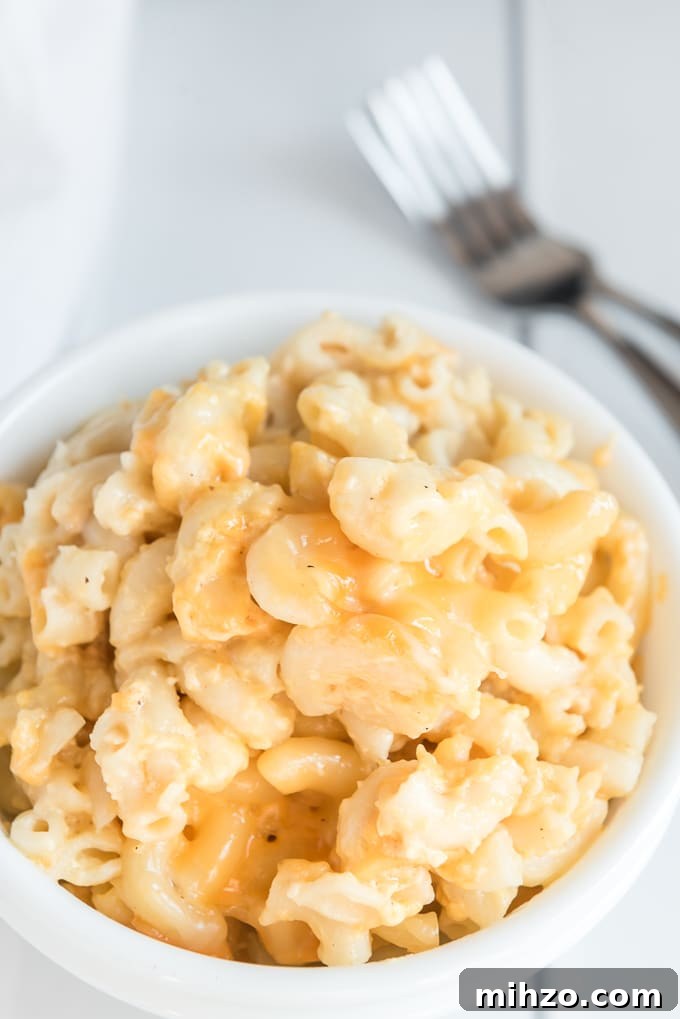 Creamy Slow Cooker Macaroni and Cheese Recipe 2 crockpot mac and cheese plated on table