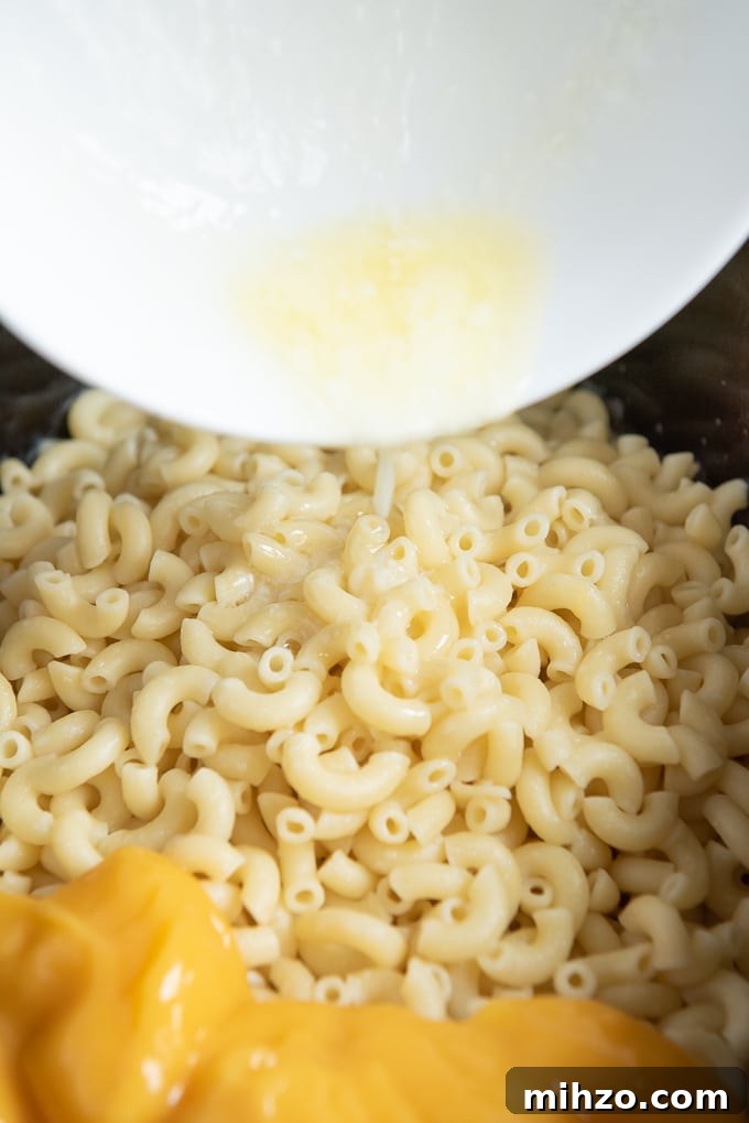 Creamy Slow Cooker Macaroni and Cheese Recipe 5 add butter to crockpot mac and cheese