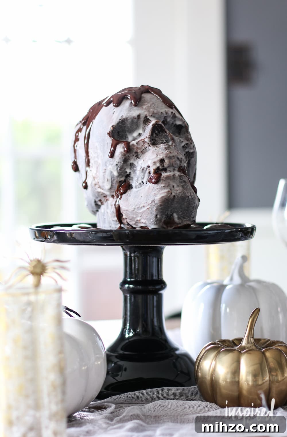 Chocolate Skull Cake Recipe: Decadent Layered Halloween Dessert 5 chocolate skull cake on black cake stand.