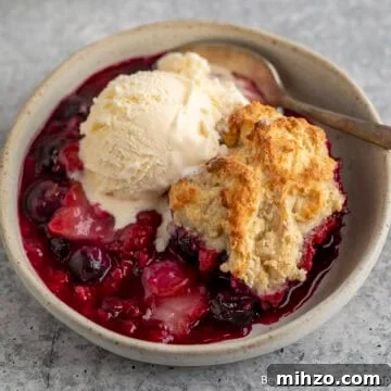 Triple Berry Cobbler topped with a scoop of ice cream.
