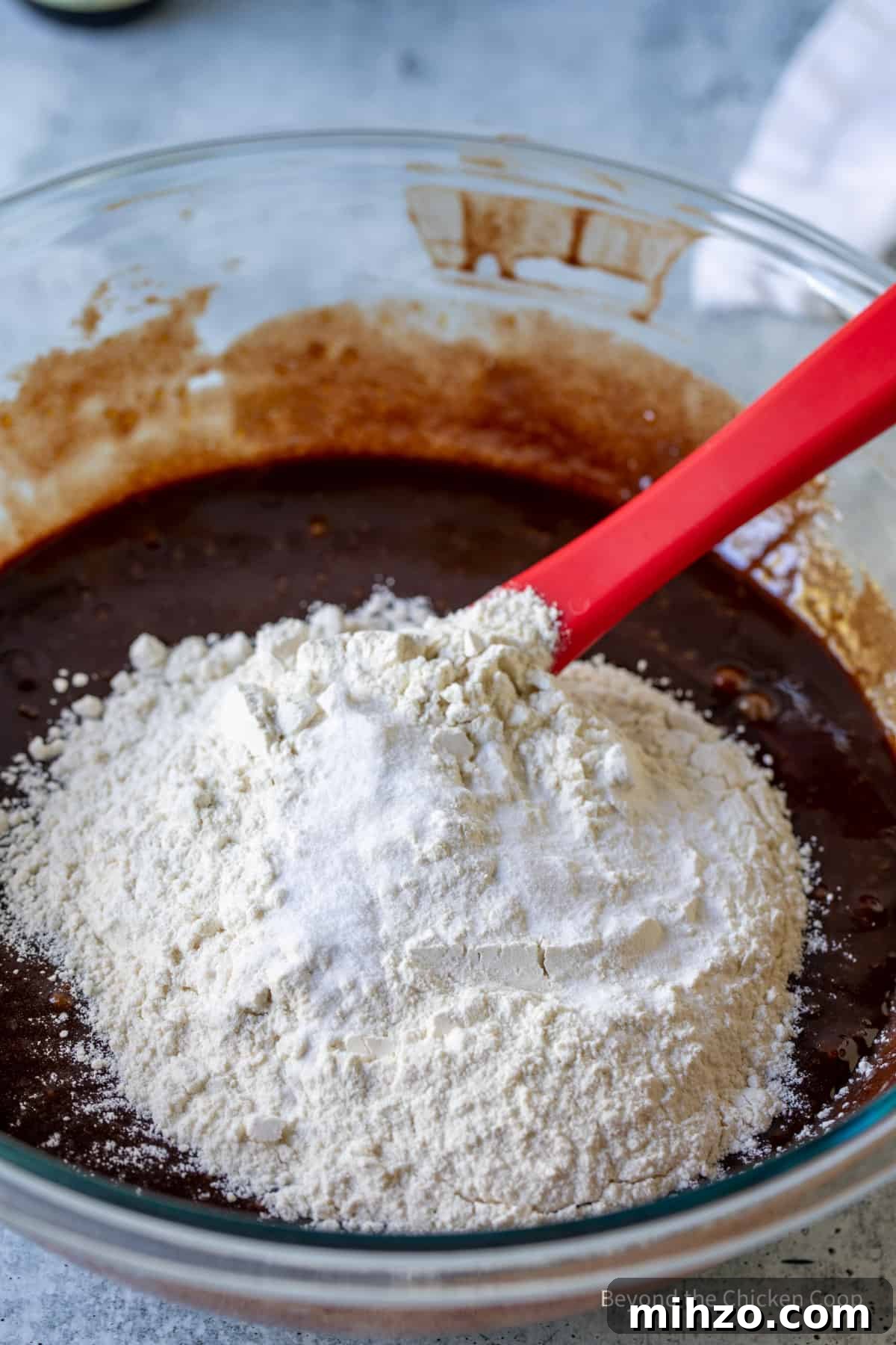 Flour being stirred into melted chocolate.