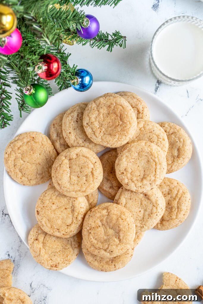 Eggnog Snickerdoodle Cookies with Warm Spices and Creamy Rum Option 3 A white plate filled with eggnog snickerdoodles with sugary outside with cinnamon and nutmeg.