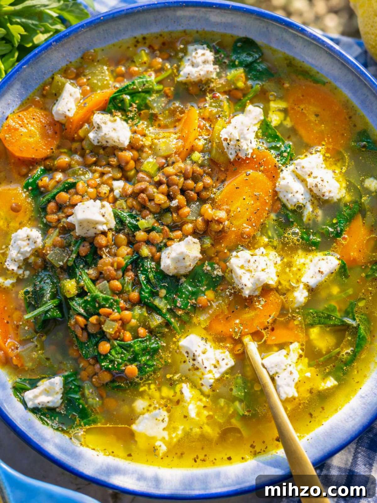 30-Minute Lemon Lentil Soup Recipe for Bright Flavor and Comfort 2 Finished lemon lentil soup served in bowl with feta and lemon slices.