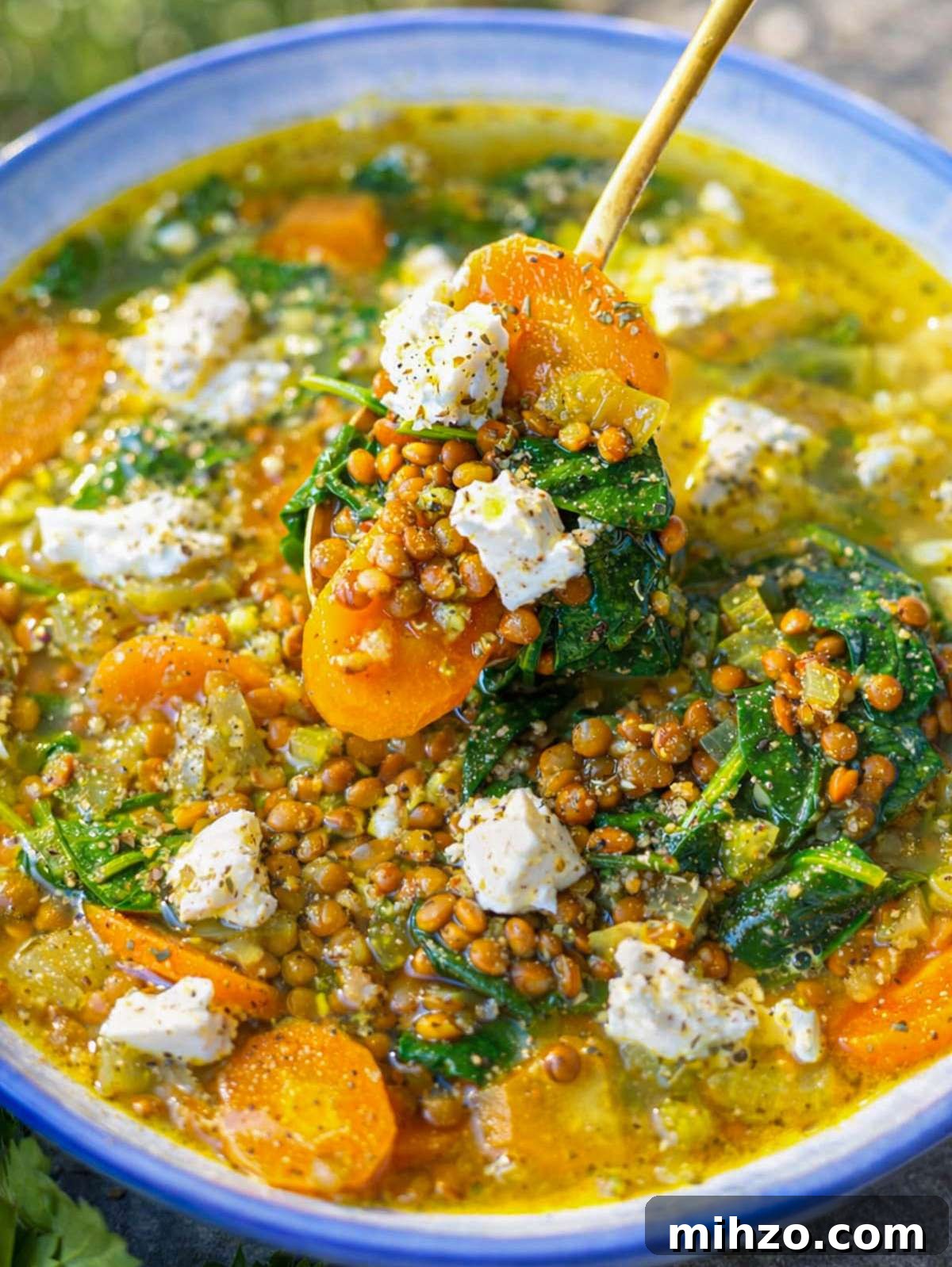 30-Minute Lemon Lentil Soup Recipe for Bright Flavor and Comfort 4 Close up lemon lentil soup showing lentils spinach and creamy feta topping.