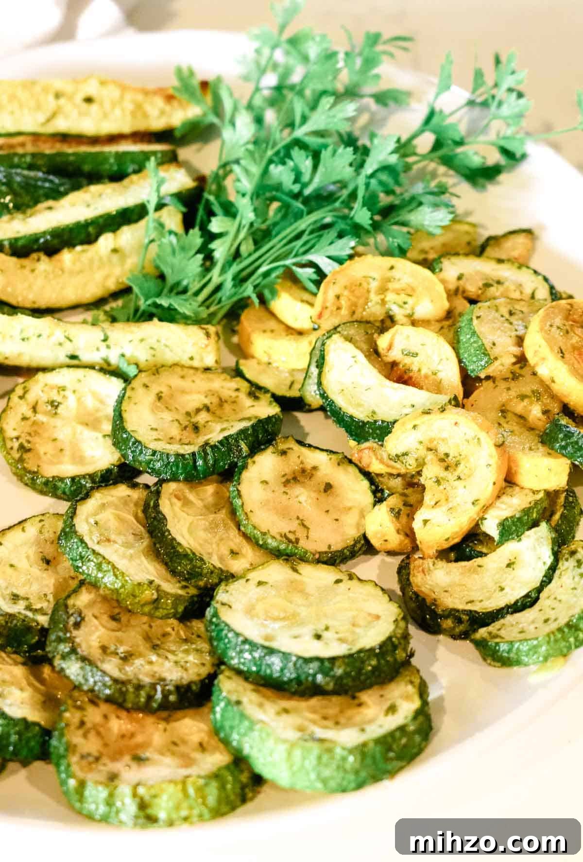 roasted zucchini rounds on white plate.