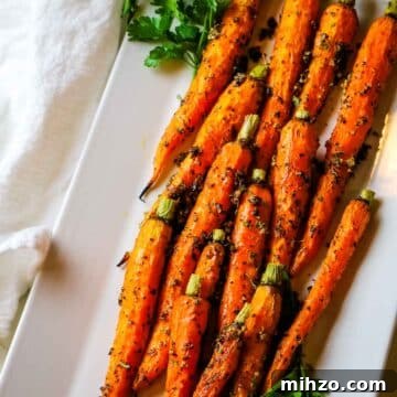roasted carrots on white platter.