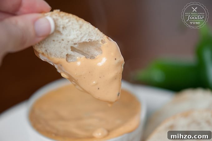 Bacon Jalapeño Football Fondue Recipe for Game Day Parties 3 dipping bread slice into warm bacon jalapeno fondue