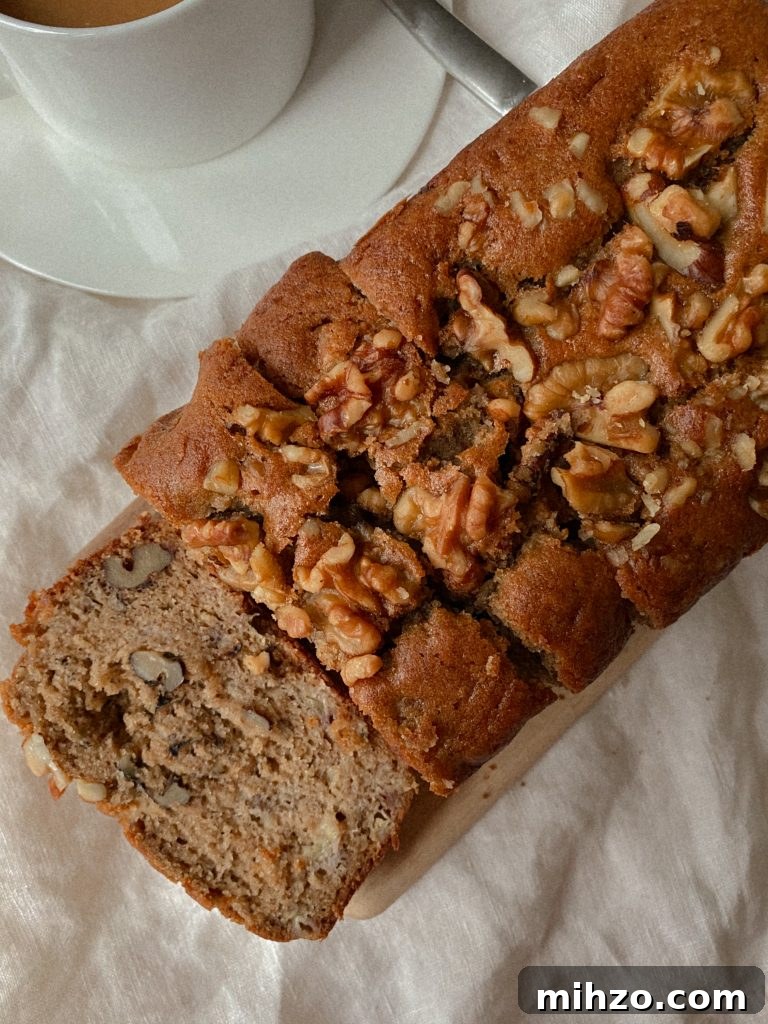 Gluten-Free Banana Bread Recipe That Actually Tastes Great 5 walnut banana bread sliced on a wood board