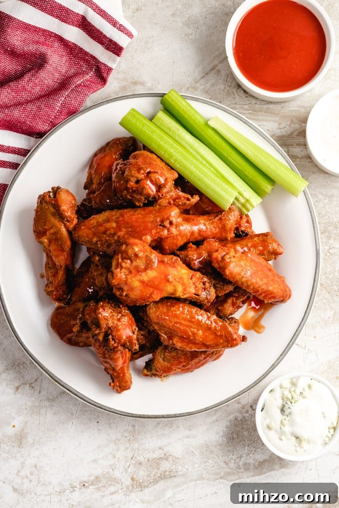 These Crispy Baked Chicken Wings are so shatteringly crisp that your guests will hardly believe that they’ve never been battered, breaded, or fried. This healthier and hassle-free recipe is a major must-make recipes for parties, and it’s all thanks to one simple, special ingredient. | hostthetoast.com img 13878 4