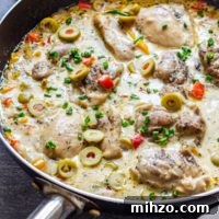 Creamy Garlic Boneless Skinless Chicken Thighs Recipe 9 Close-up of creamy boneless skinless chicken thighs with olives and peppers in a creamy skillet sauce.