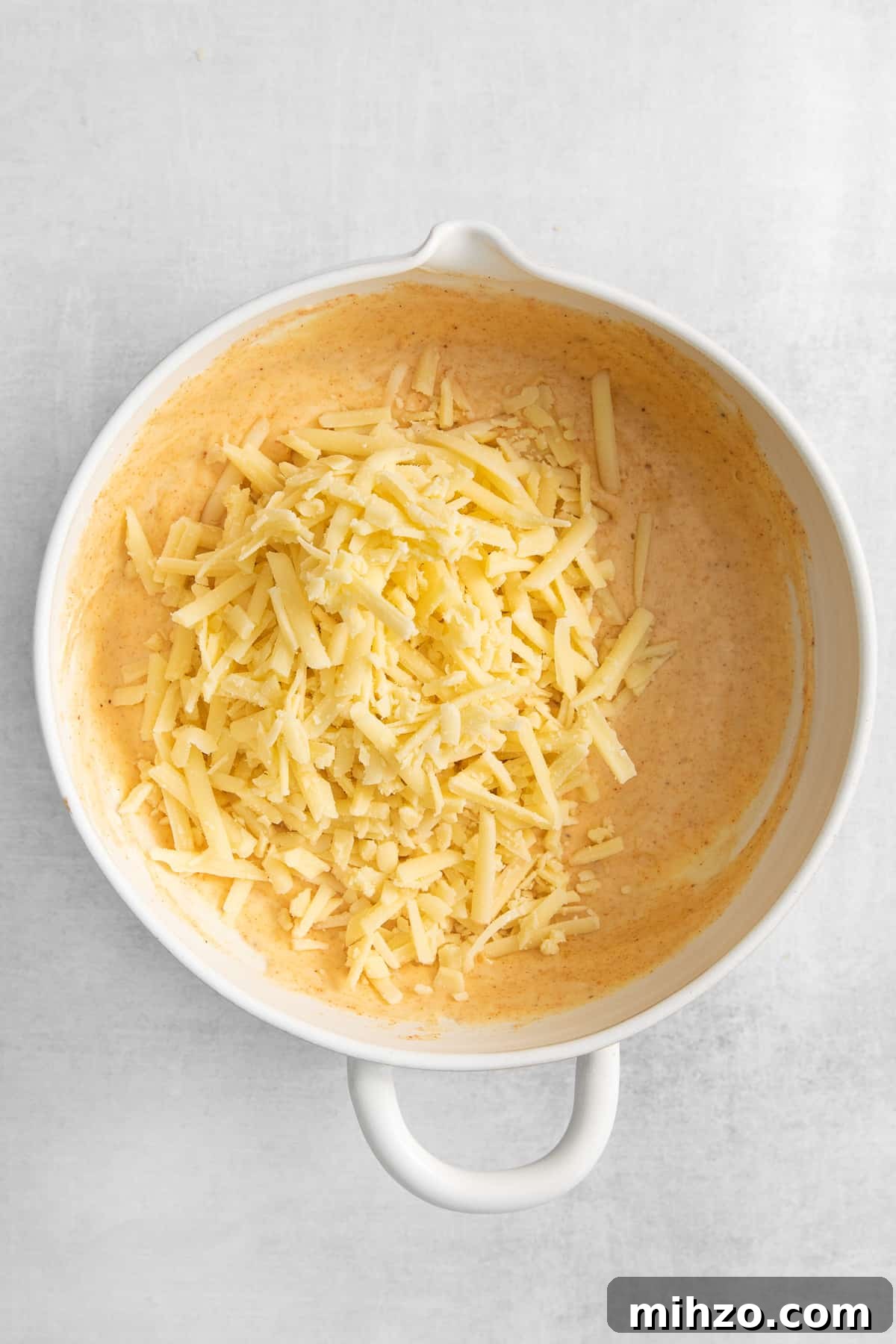 Cheese souffle ingredients in a bowl.