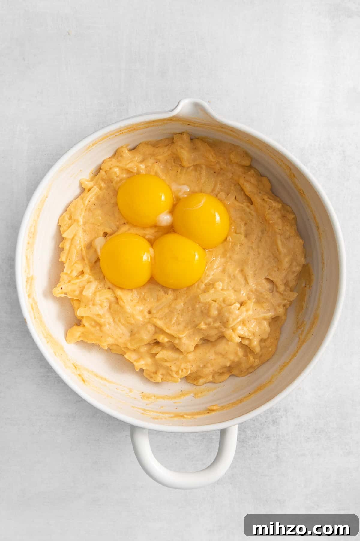 Egg yolks in a cheese souffle mixture.