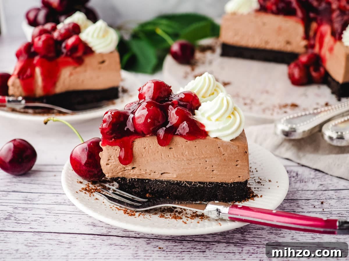 Slice of black forest cheesecake on a plate with a fork.