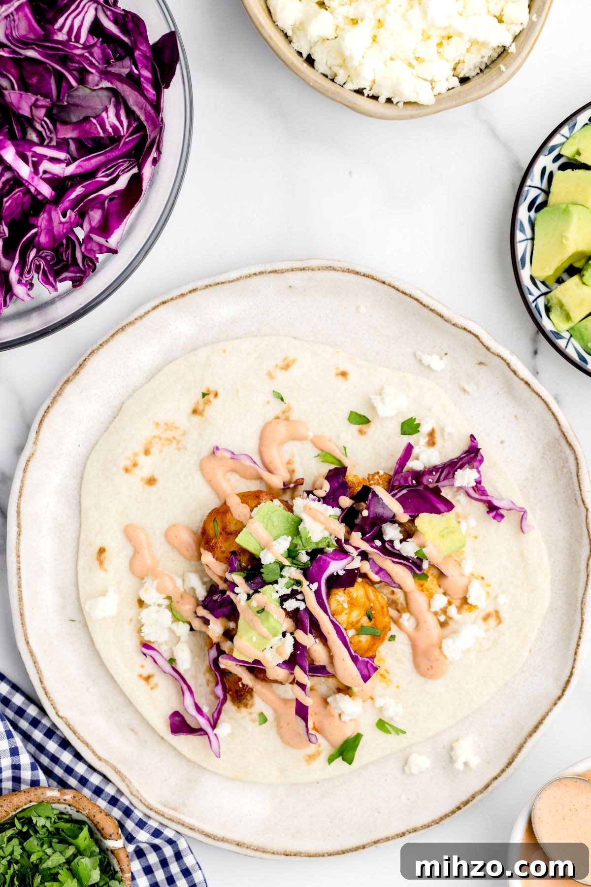 Crispy Air Fryer Shrimp Tacos with Lime Slaw and Spicy Mayo 8 Prepared shrimp taco drizzled with sauce