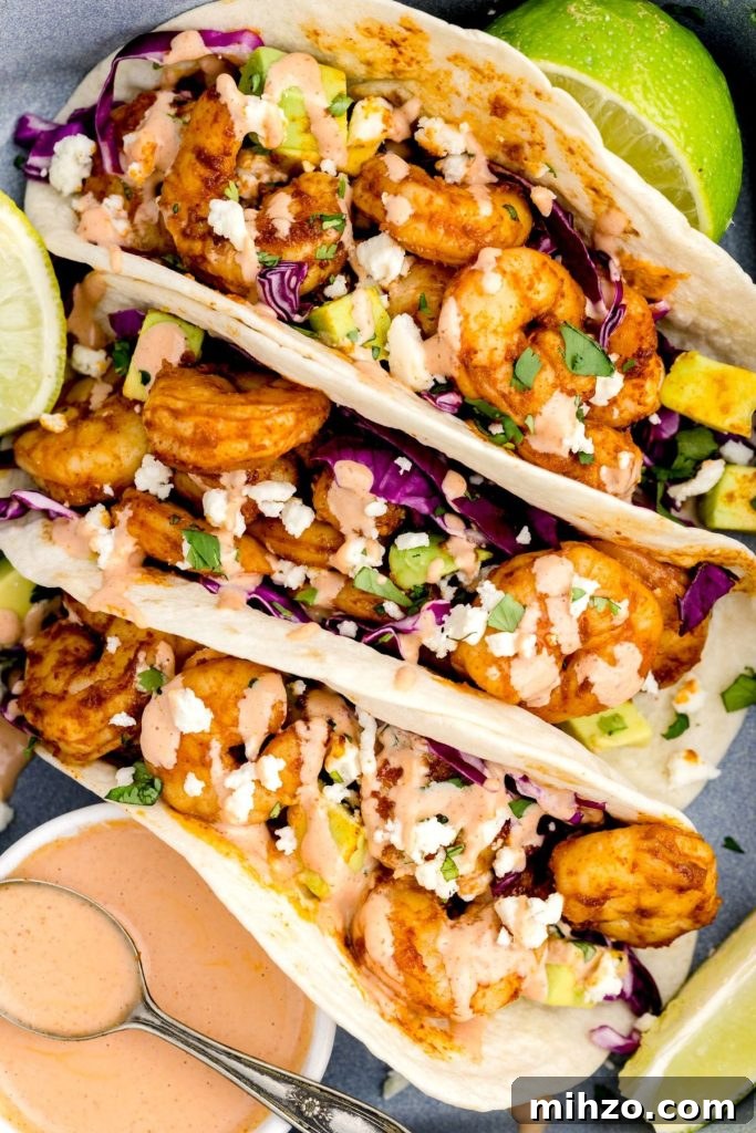 Crispy Air Fryer Shrimp Tacos with Lime Slaw and Spicy Mayo 9 Shrimp tacos in a pan with lime wedges