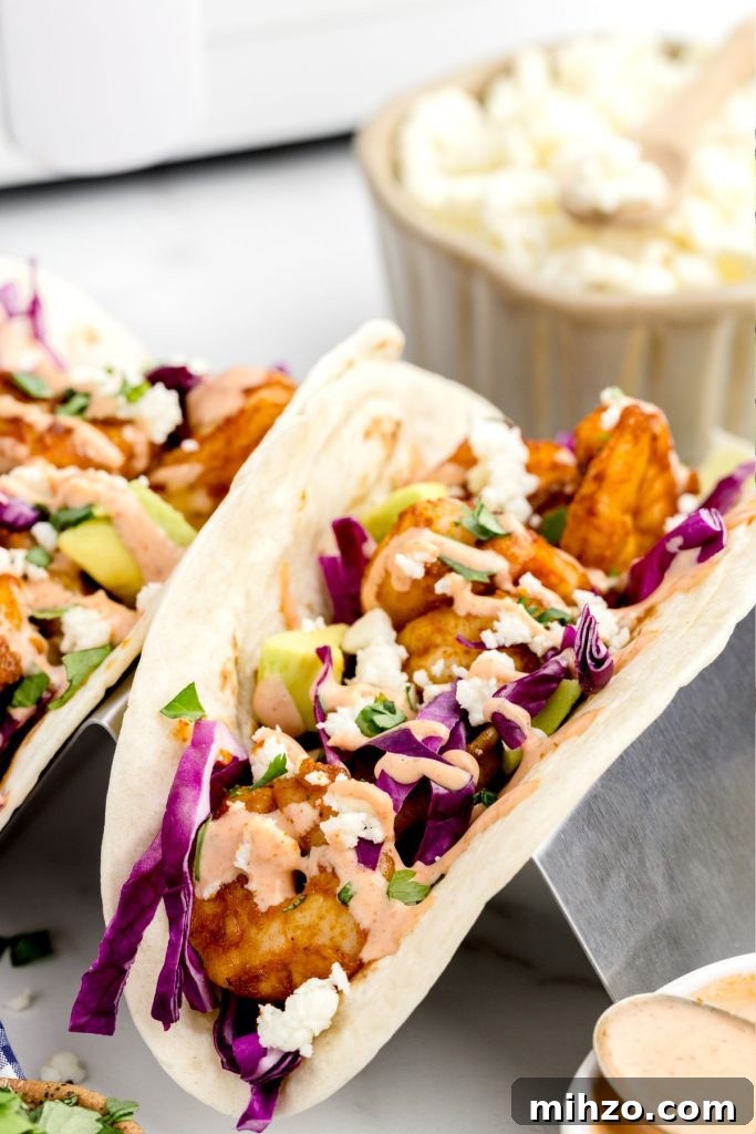 Crispy Air Fryer Shrimp Tacos with Lime Slaw and Spicy Mayo 10 Stacked shrimp tacos in a holder