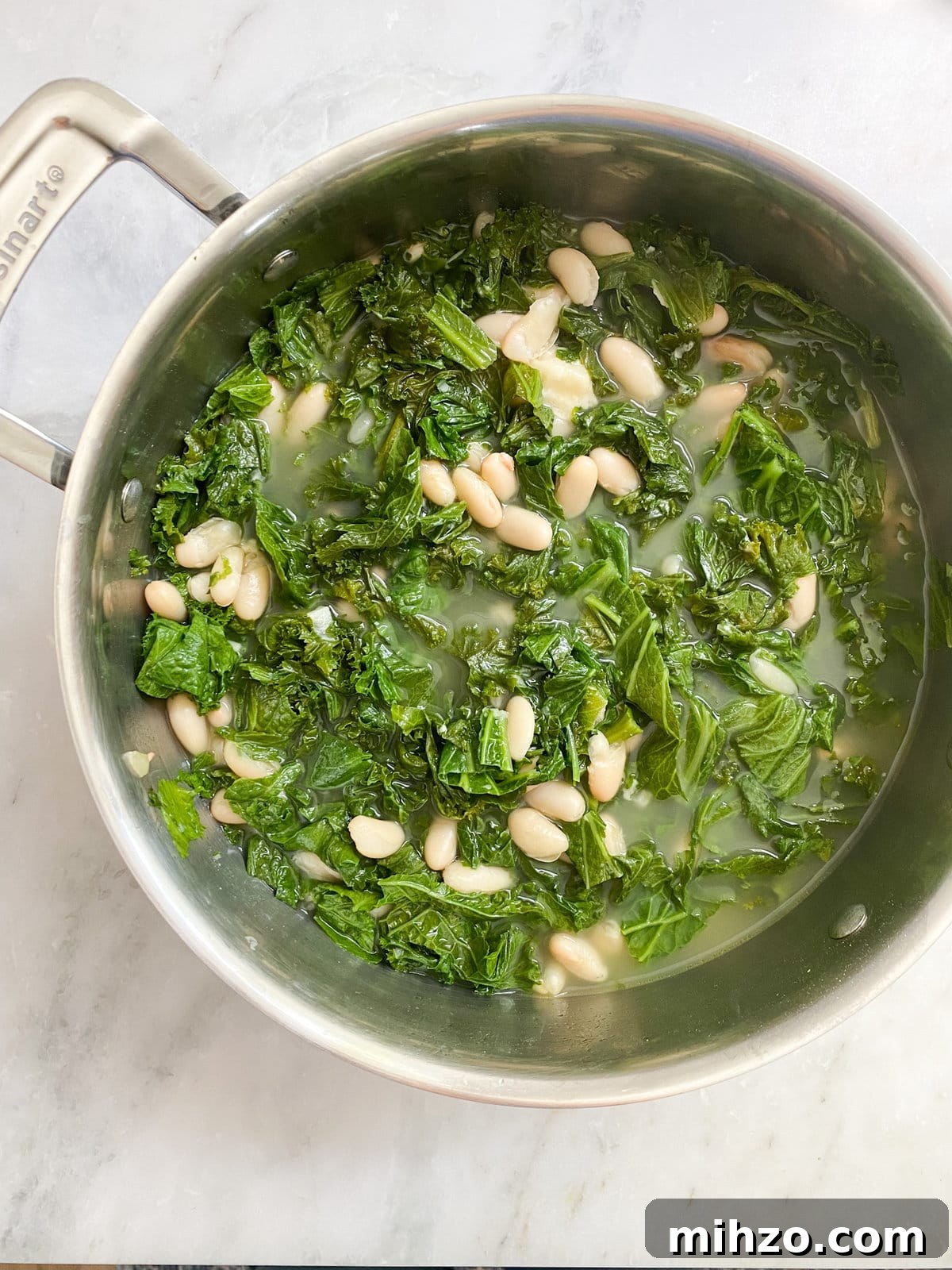 Beans and greens in a pot after cooking. 