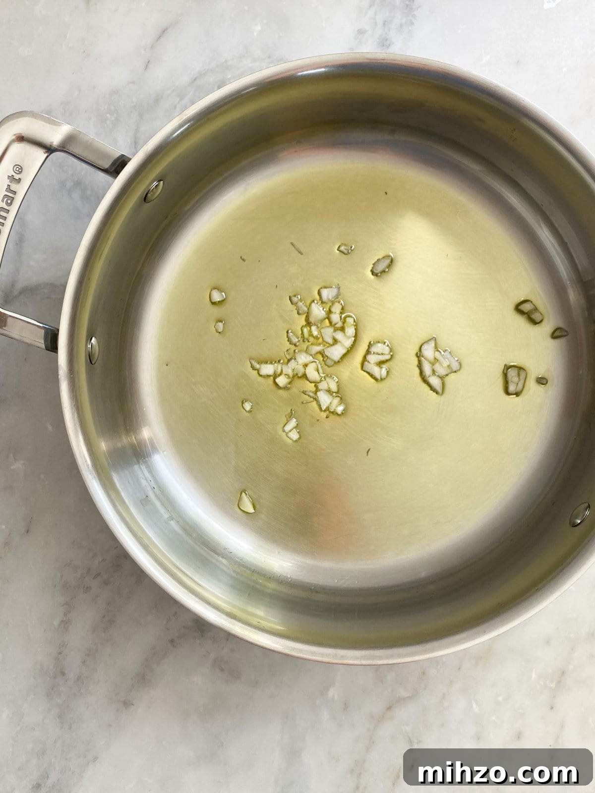 Sautéing garlic in olive oil.