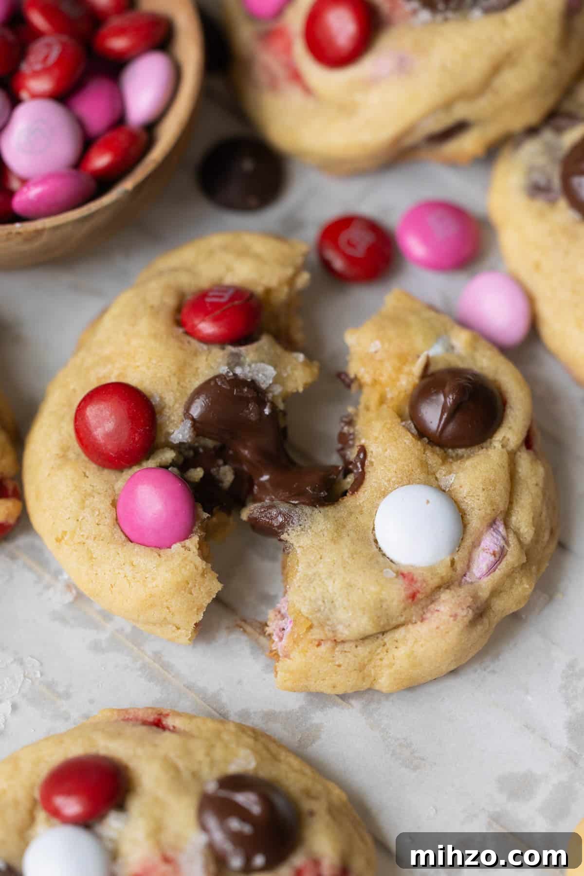 Valentine’s Day M&M Cookie Recipe: Festive Chocolate Cookies 5 a cookie pulled a part with melty chocolate in the middle.