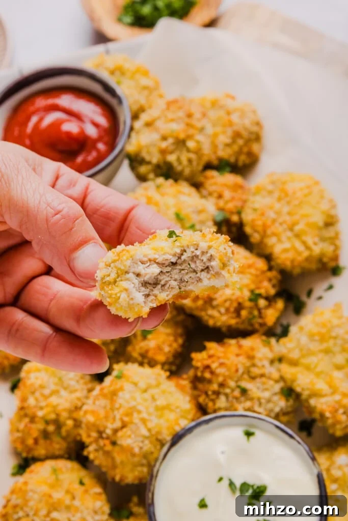 A cauliflower chicken nugget with a bite taken out.