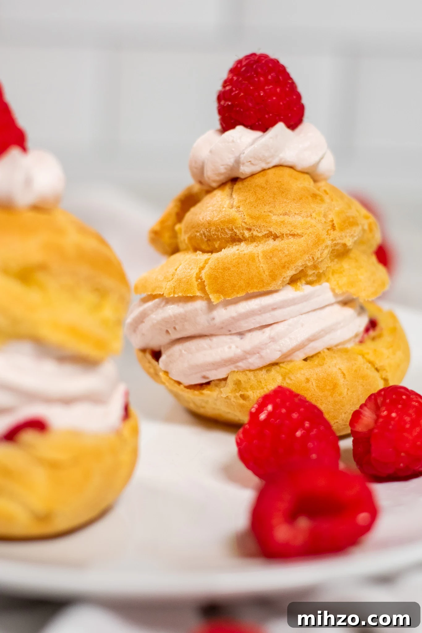 Raspberry Choux Pastry Fastelavnsboller Recipe 2 A choux pastry bun filled with raspberry cream cheese whipped cream and raspberry jam.