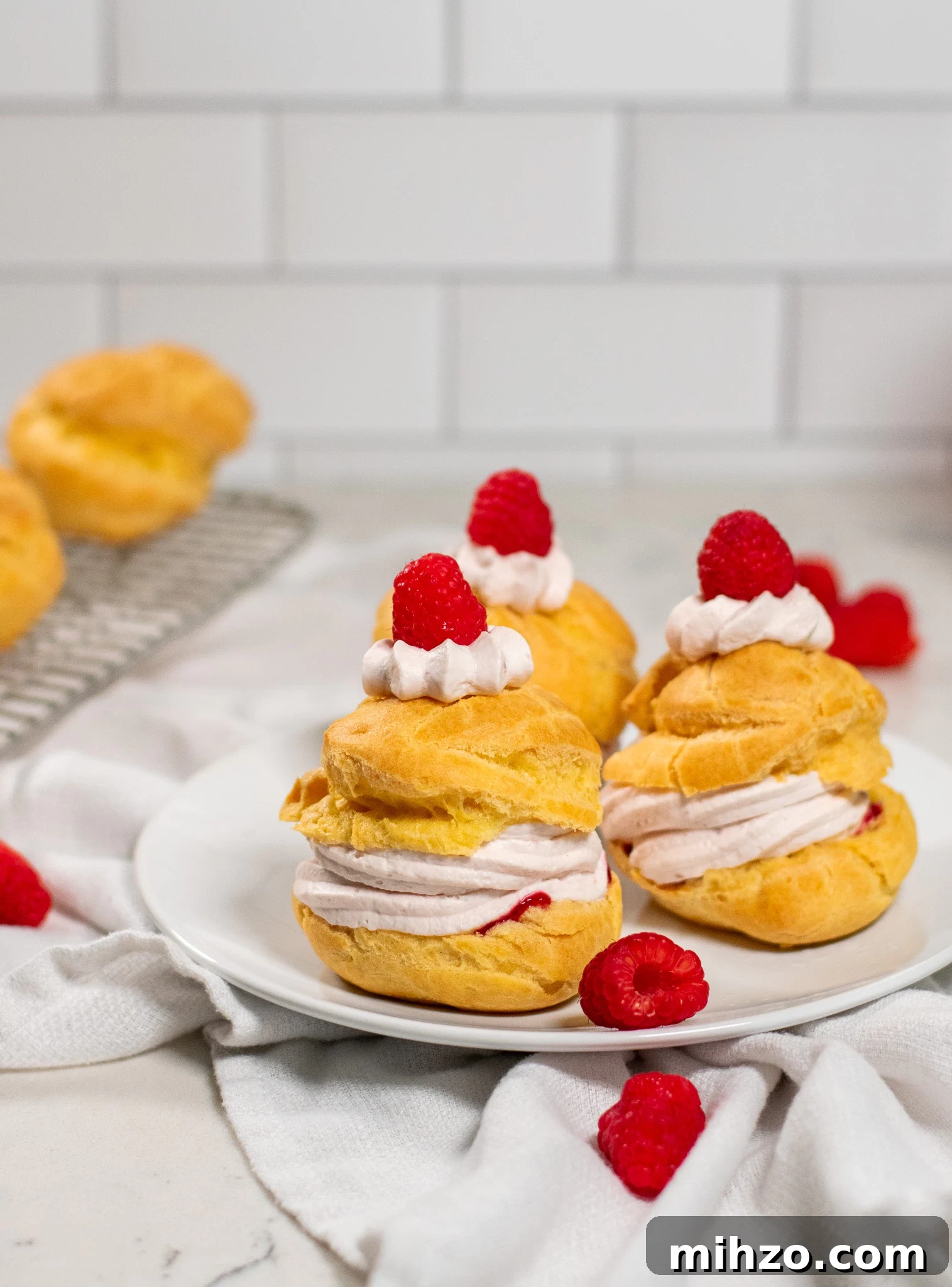 Raspberry Choux Pastry Fastelavnsboller Recipe 4 A choux pastry bun filled with raspberry cream cheese whipped cream and raspberry jam.